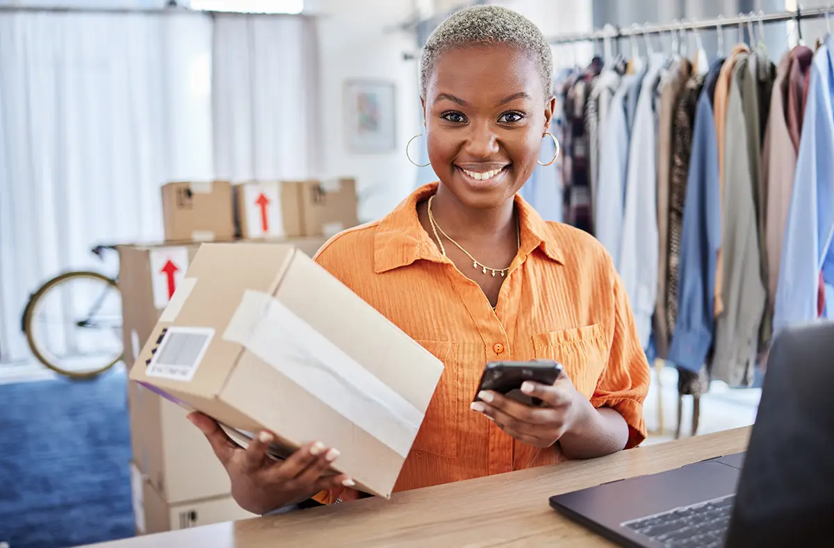 Small business owner holding a parcel is happy because she can get discounted shipping rates for free